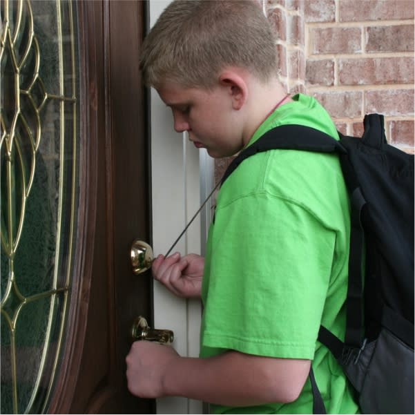 child unlocking the door to their home