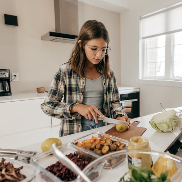 teenager cooking on her own